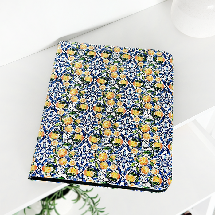 Coconut Lane notebook with lemon and blue floral cover next to matching Amalfi Lemon iPad case.
