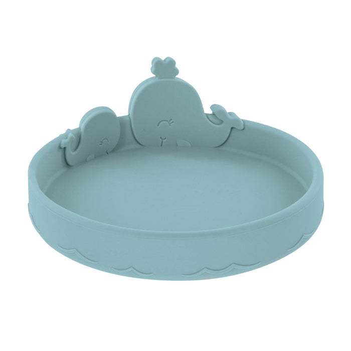 The Animal Friends 6-Piece Dinnerware Set - Blue Whale features a round, light blue silicone plate with raised edges, wave patterns, and adorable whale figures—ideal for baby feeding and self-feeding utensils.