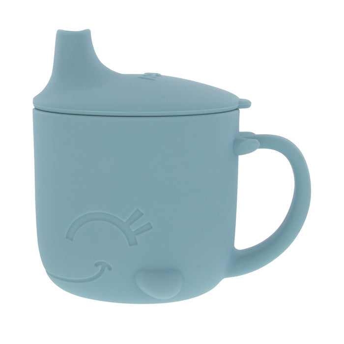 The Animal Friends 6-Piece Dinnerware Set - Blue Whale features a light blue silicone sippy cup shaped like a whale, with a spout lid, handle, and embossed details—ideal for easy self-feeding as part of any baby feeding set.