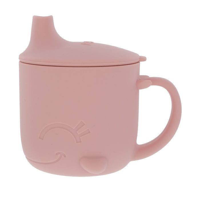 The Nuby Animal Friends 6-Piece Dinnerware Set - Pink Whale features a pink silicone sippy cup with handle, spout lid, and a raised smiling face—ideal for baby feeding or encouraging self-feeding with safe, durable tableware.