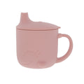 The Animal Friends One-Handle Silicone Sippy Cup is a pink, spill-proof cup with a handle and spout lid, featuring an embossed smiling face—perfect for toddlers learning to drink independently.