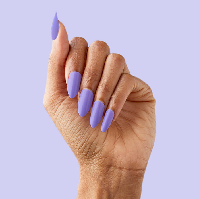 Bold & Unshaken - Press-On | Long | Almond showing hand with long almond press-on nails in vibrant purple polish on lavender background