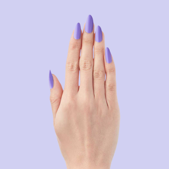 Bold & Unshaken - Press-On | Long | Almond showing hand with long almond press-on nails in vibrant purple polish on lilac background
