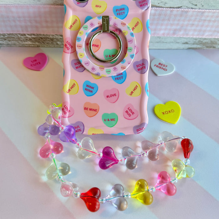 Candy hearts phone charm with translucent rainbow heart beads and crystal accents on conversation hearts phone case