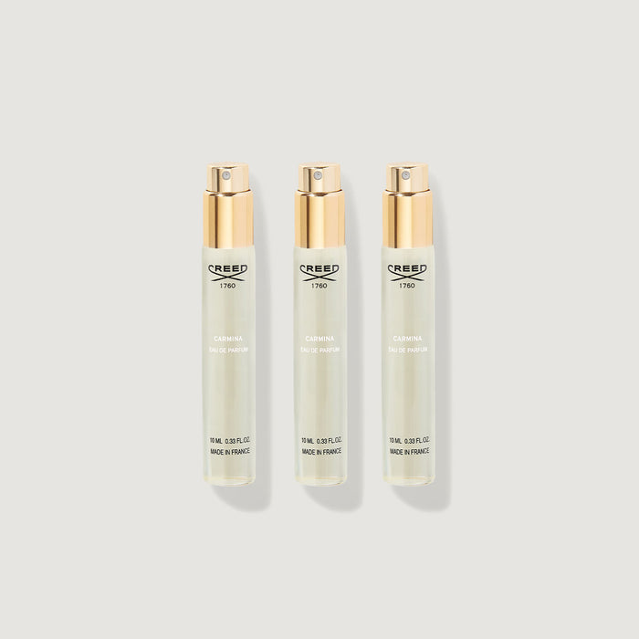 Three Creed Carmina 10ml Eau de Parfum atomiser refill vials with gold caps - Flat Lay | Creed Fragrances