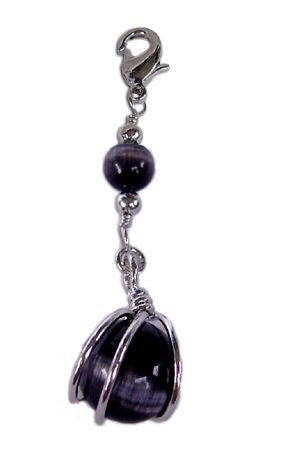 Close-up of silver ball hair charm with deep black bead detail
