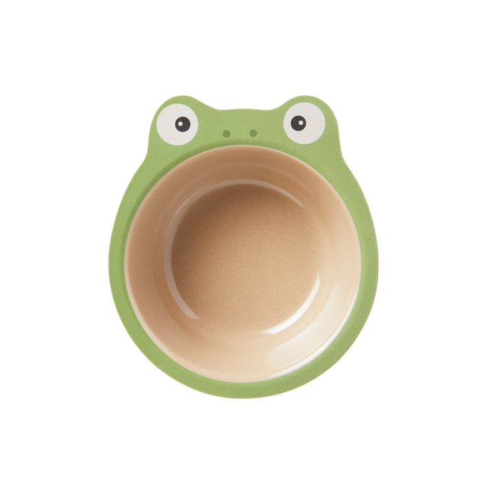 The Nuby Eco Rice Husk Bowl is a round, biodegradable children’s bowl with a green frog-face rim, beige interior, and features eyes and nostrils on top. Photographed on a white background.