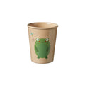 The Eco Rice Husk Drinking Tumbler in beige features a smiling green frog on the front, with a small blue dragonfly to the left and a dashed line tracing the dragonfly's flight path.