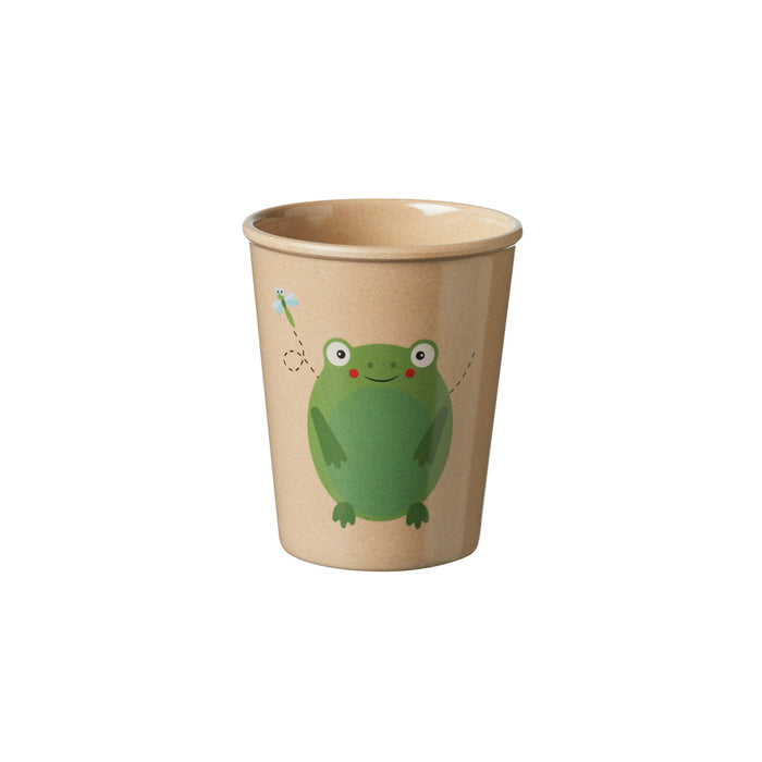 The Eco Rice Husk Drinking Tumbler in beige features a smiling green frog on the front, with a small blue dragonfly to the left and a dashed line tracing the dragonfly's flight path.