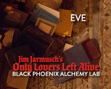 Stack of books with a textured background and text overlay for 'EVE', 'Jim Jarmusch's Only Lovers Left Alive', and 'Black Phoenix Alchemy Lab'.