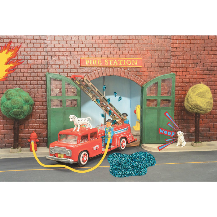 Toy fire station set with a red fire truck, ladder, and fire hydrant.
