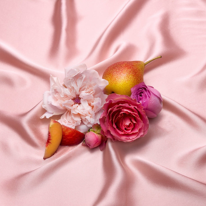 Fruits and flowers on a pink fabric background