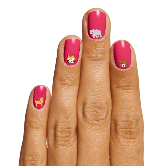 Hand with bright pink gel polish and Furry Friends nail art stickers showing lion, tiger, elephant, and bear faces for mani