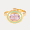 a gold ring with a purple stone