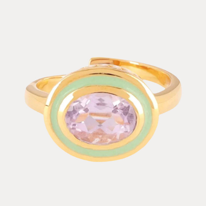 a gold ring with a purple stone