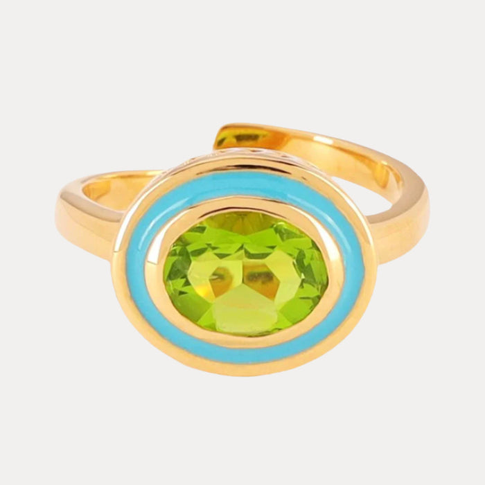a gold ring with a green stone in the middle