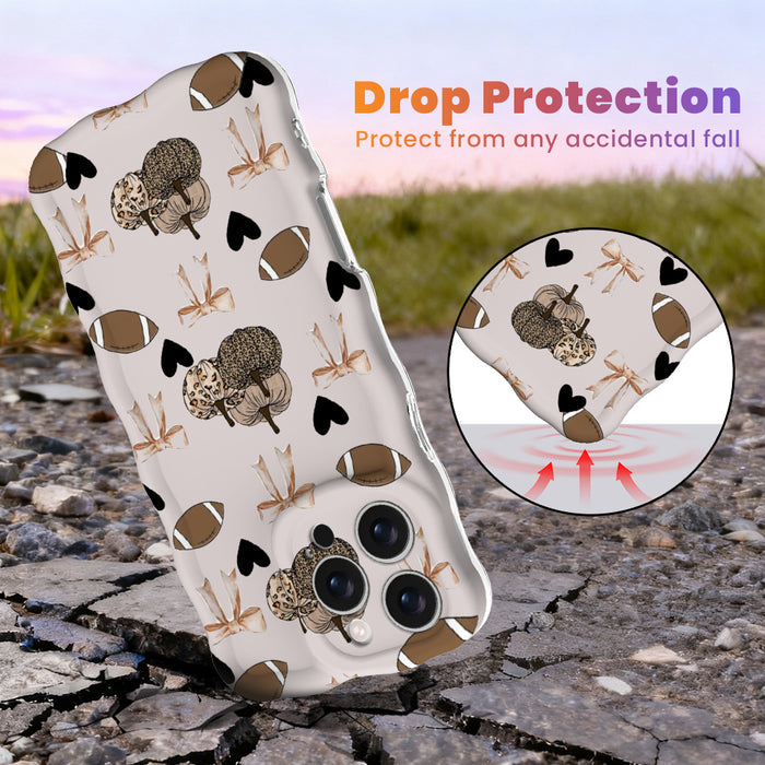 Game Day Darling Wavy Luxe MagSafe iPhone case with a cream coquette print of footballs, leopard pumpkins, bows and hearts from Fancy Bands