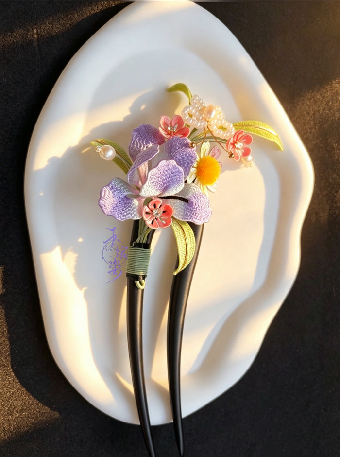 A handmade Chanhua iris hairpin with colorful flowers and leaves on a white plate-2