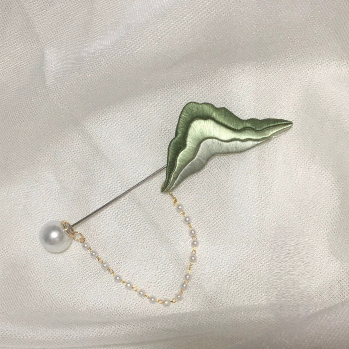 Chanhua handmade green thread mountain brooch with pearl drop and pearl-beaded gold chain, displayed on white fabric