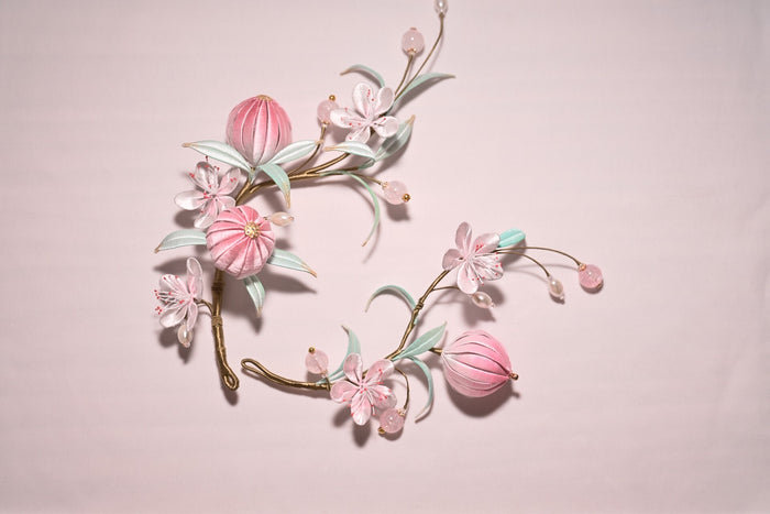 Handmade Chanhua peach blossom hairpins set with pink flowers and leaves on a light background