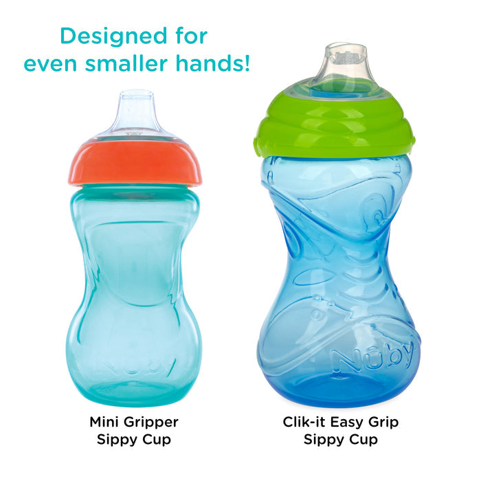 Two blue Nuby Mini Gripper Soft Spout Sippy Cups (2 Pack) are shown side by side—one with an orange lid, one with a green lid. Both have soft spouts and are leak-resistant. Text above says: Designed for even smaller hands!.