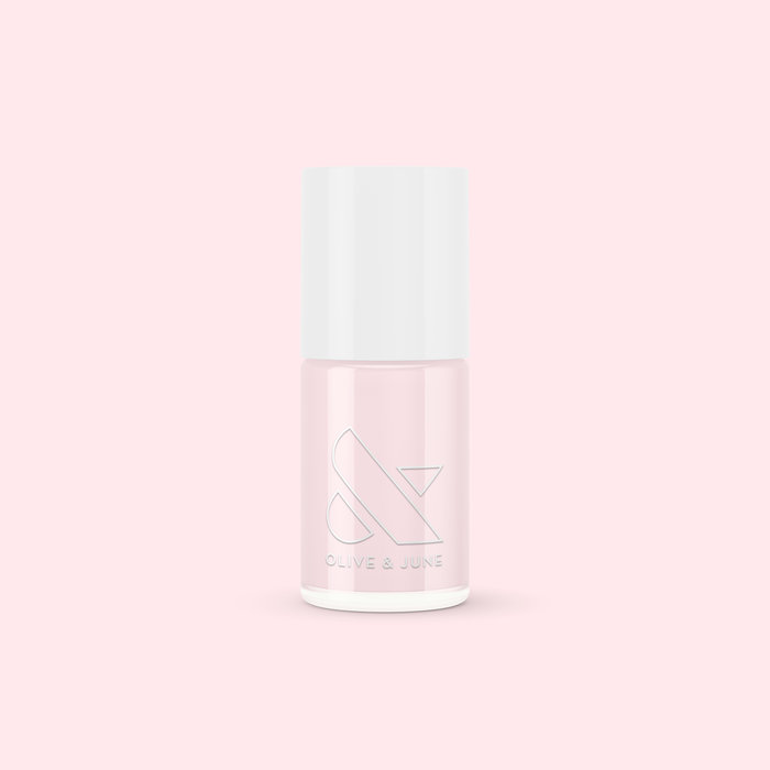 Bottle of Olive and June PINK SANDS nail polish in soft sun-bleached pink for an easy at-home mani or pedi