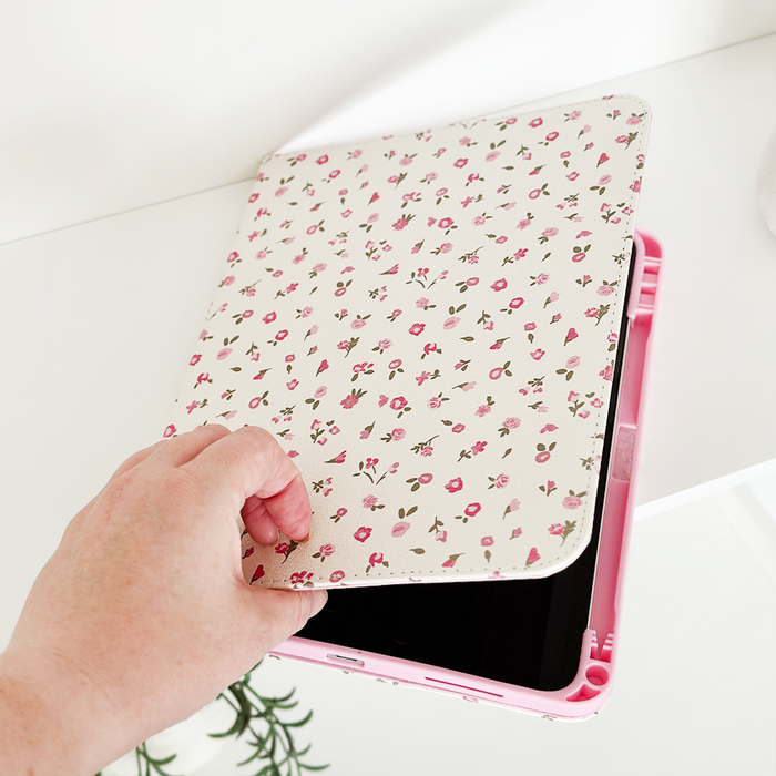 Pink watercolor floral iPad case from Coconut Lane, shown on an iPad being opened on a white surface.
