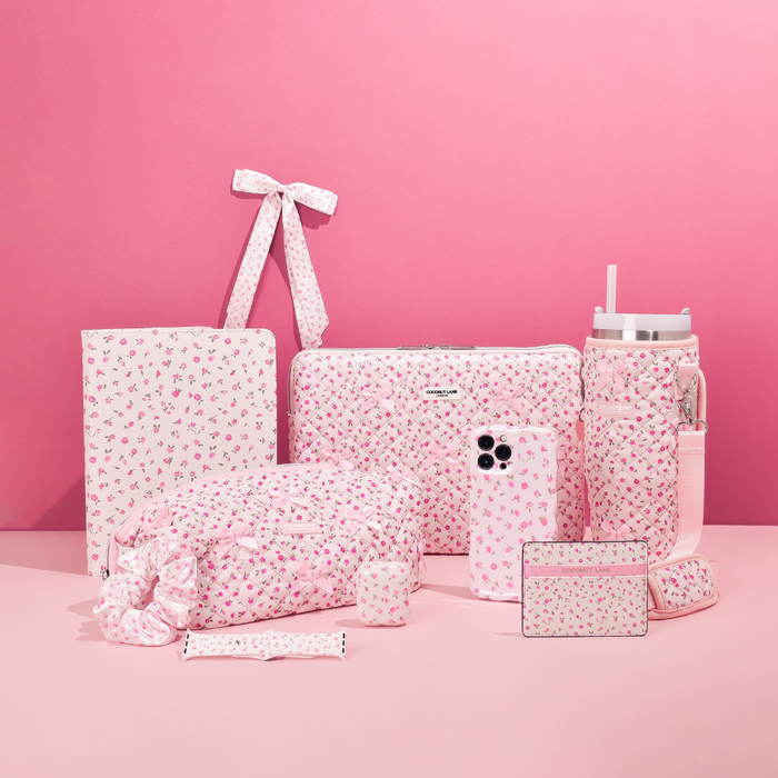 Pink Watercolour Flowers iPad case by Coconut Lane on a soft pink background with quilted floral accessories nearby.
