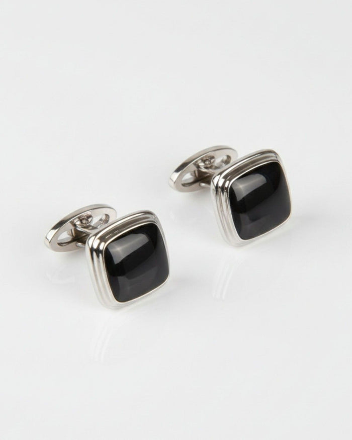 Silver cufflinks with black glossy square cushion fronts, hinged back design