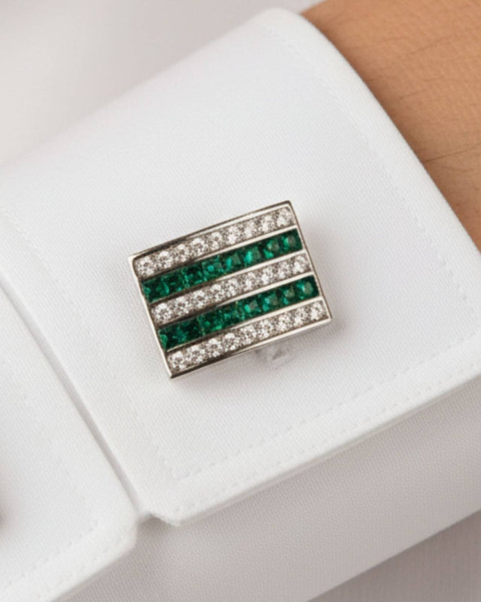 Square cufflink close-up with green crystal stripes and clear pavé border