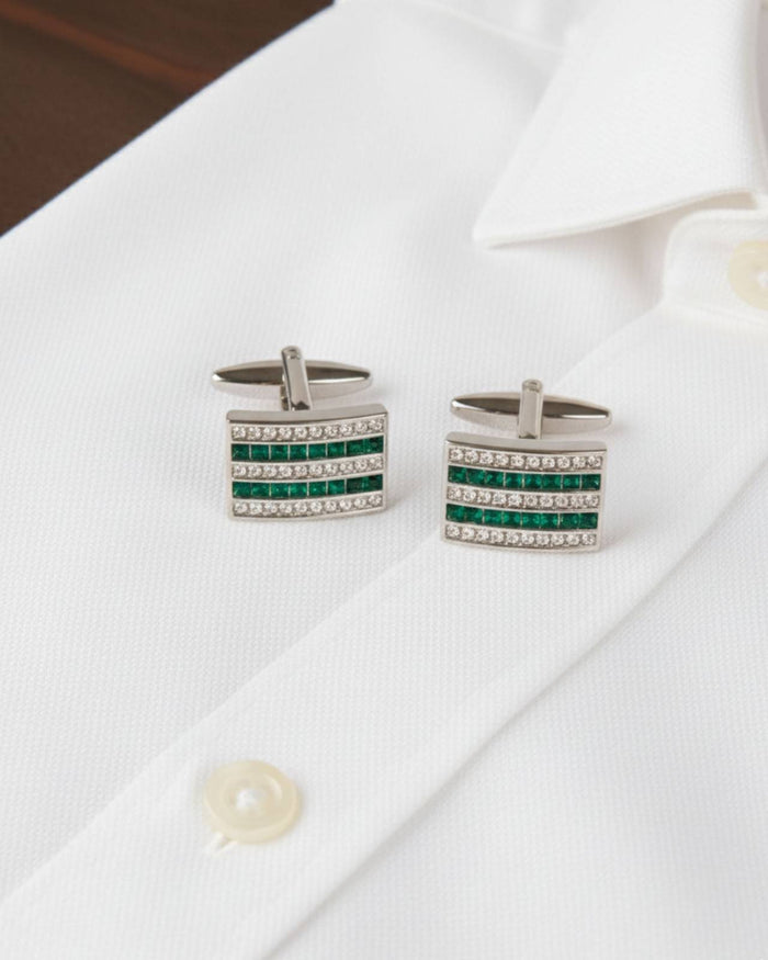Silver square cufflinks with green crystal stripes and clear stones on white shirt