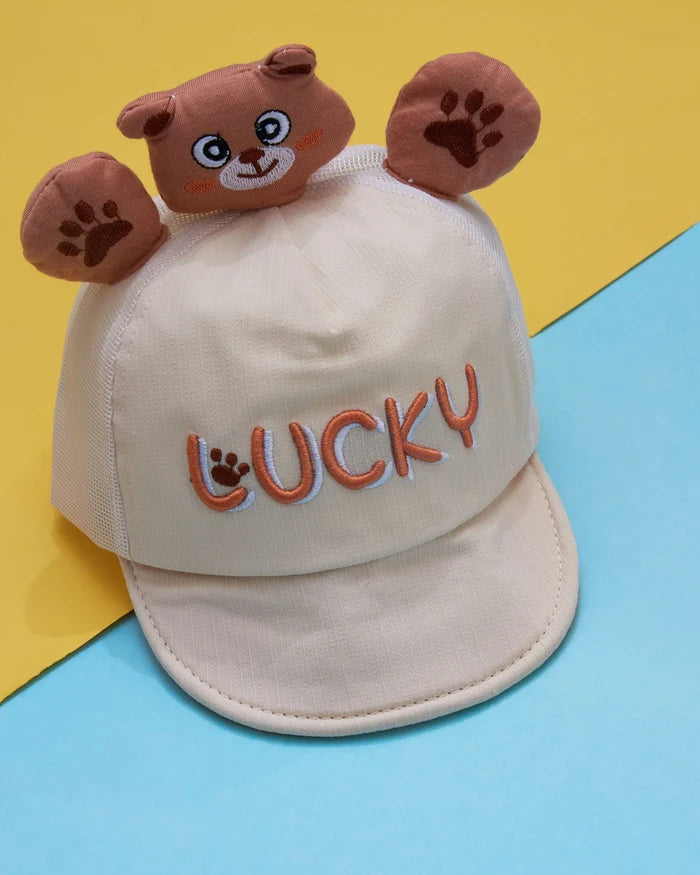 Boys cap in white with brown bear face, paw prints, and 'LUCKY' embroidery