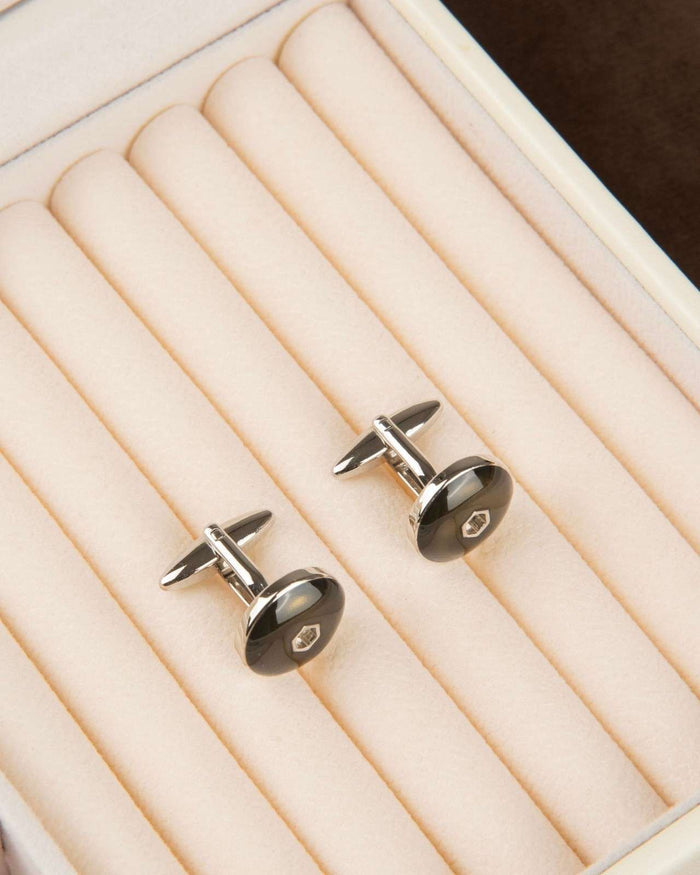 Men's round cufflinks with dark enamel fronts and metal hex emblem