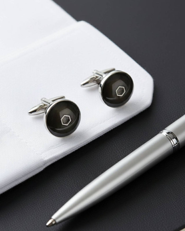 Men's round cufflinks with dark enamel finish and metal hex emblem on cuff