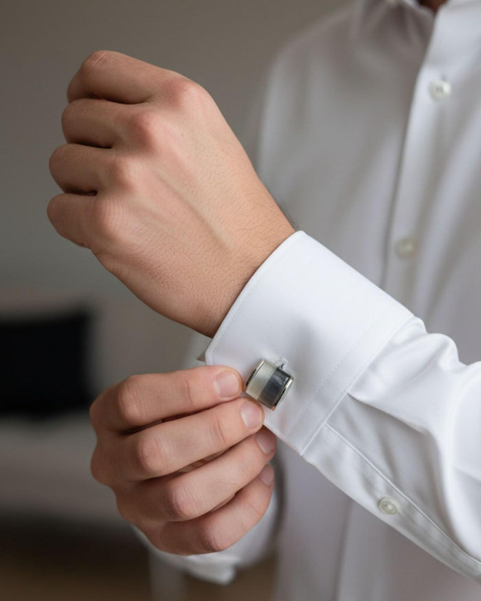 Silver-tone rectangular cufflinks with gradient inlay on white shirt cuff