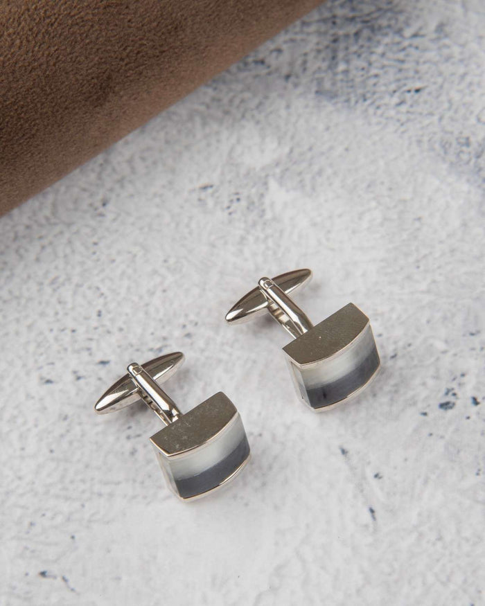 Silver-tone curved rectangular cufflinks with gradient inlay, front view