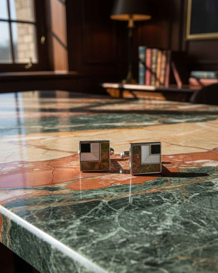 Square cufflinks with silver frames, black enamel squares and abstract stone inlay.