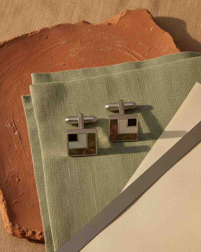 Pair of square cufflinks with silver posts, black enamel and multicolor stone inlay.