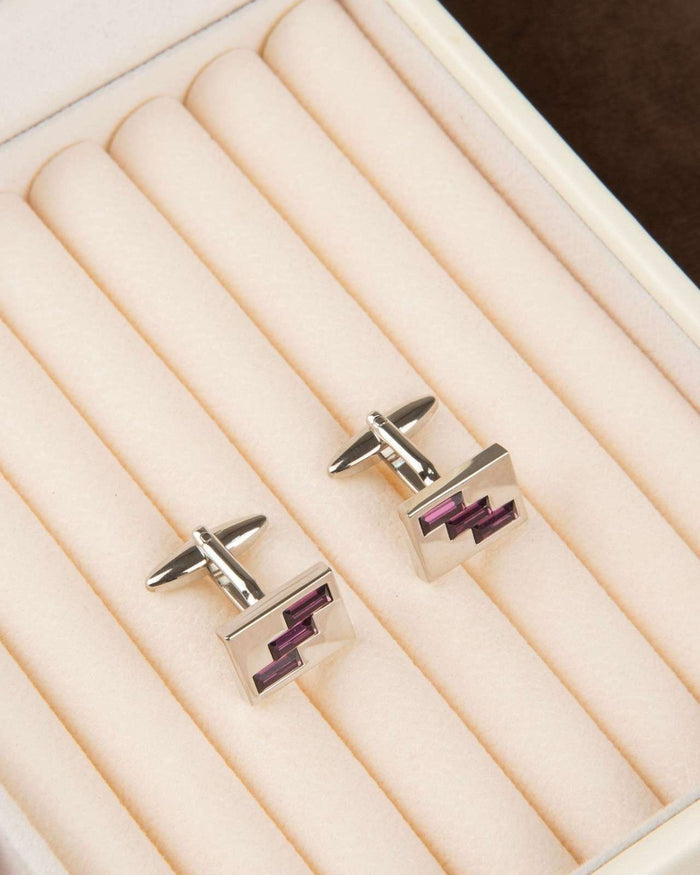 Men's square silver-tone cufflinks with purple geometric crystal on a lined display