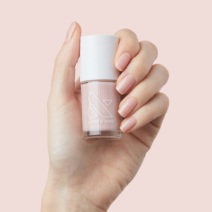 Hand with nails polished in neutral mauve using The Queen Takes her Tea with Milk for a natural mani