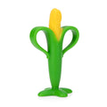 The Soothing Corn Teether, a yellow and green silicone teether with two loop handles and a wide stable base, stands upright on a white background to provide soothing relief for babies.