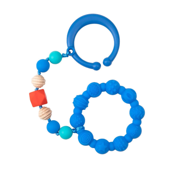 The Nuby Tag-a-Long Teether features a blue silicone ring with textured blue, turquoise, cream, and red beads on a round blue clip—ideal as a stroller teether or soothing baby teething toy for relief on the go.